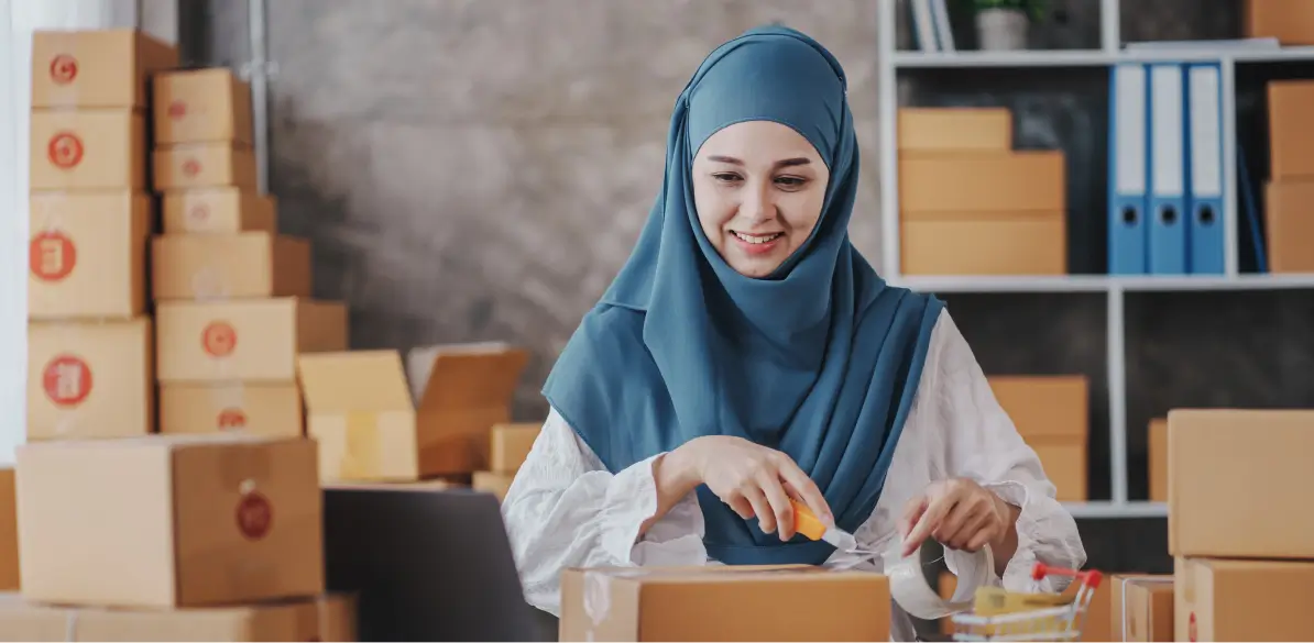 A brand owner packing orders for a direct-to-consumer brand