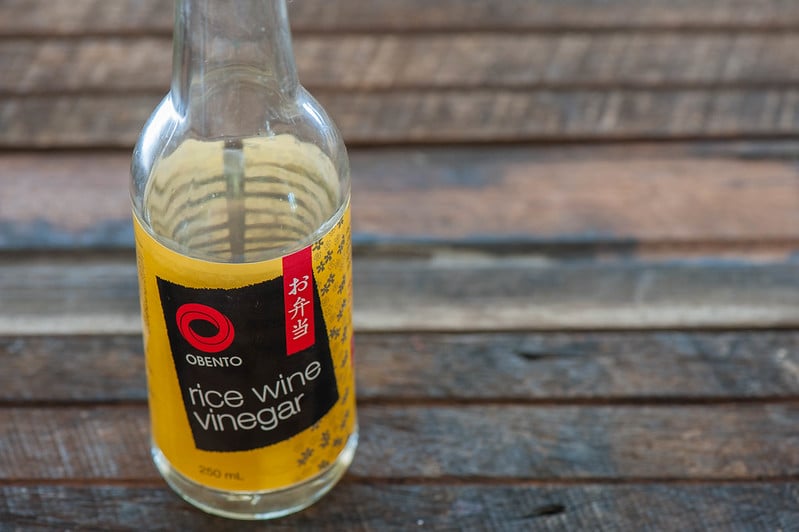 A bottle of Obento Rice Wine Vinegar on top a wooden table