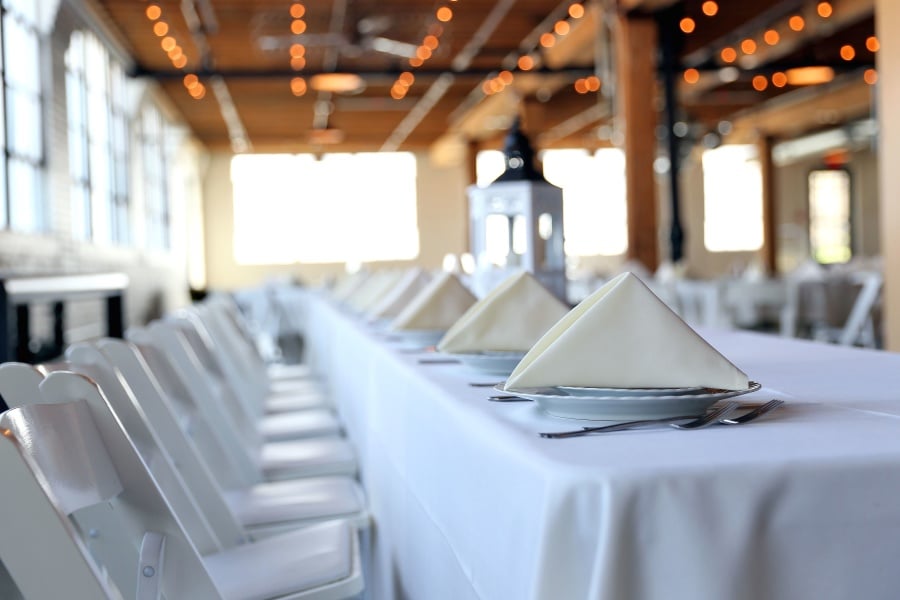 White tablecloths, chairs, and place settings at a fine restaurant