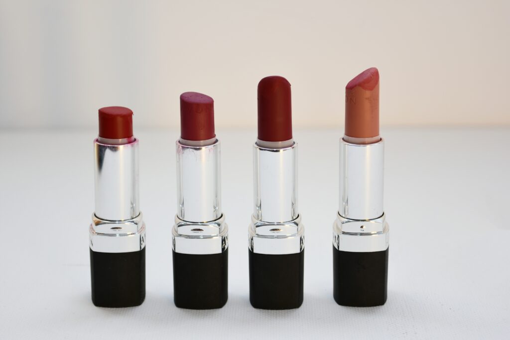 Four Assorted-color Lipsticks standing in a row